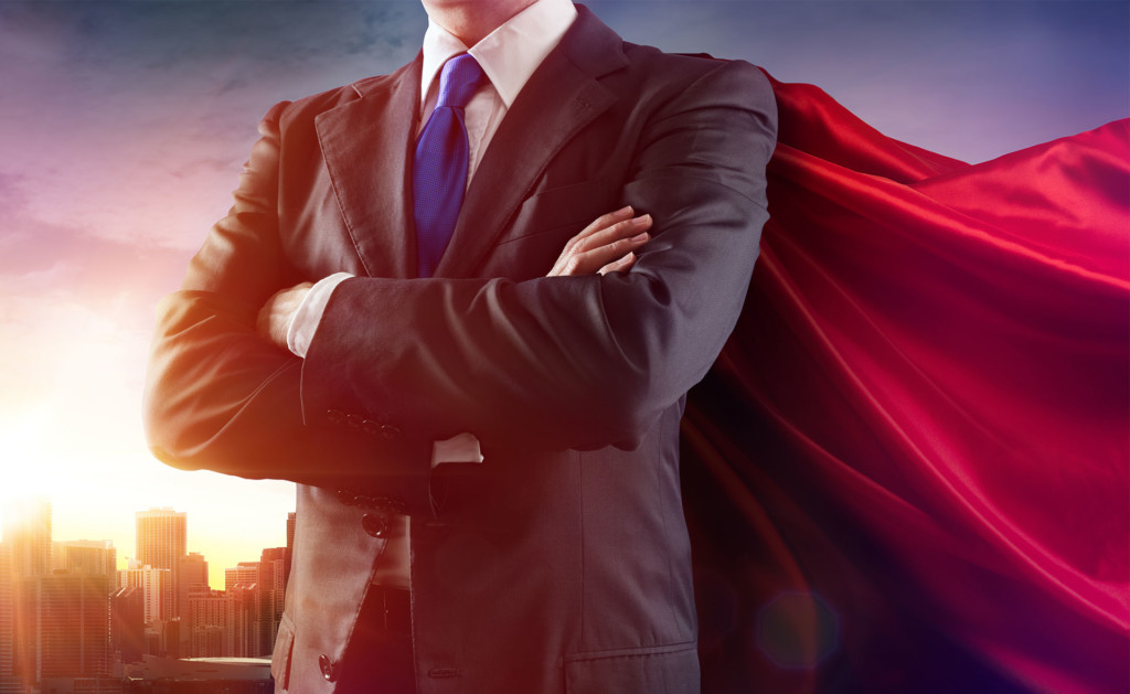 A picture of a CEO wearing a cape on the back of his business suit.