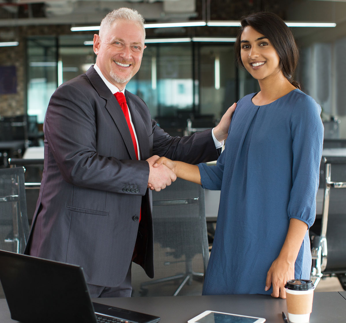 Offer-Congratulations Picture of a boss shaking his employee's hand to congratulate her on finding a new job.