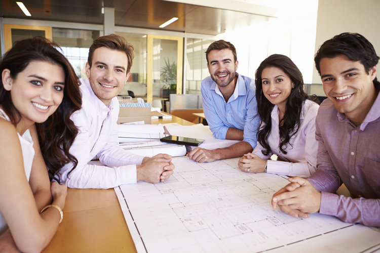 Smiling employees at meeting table