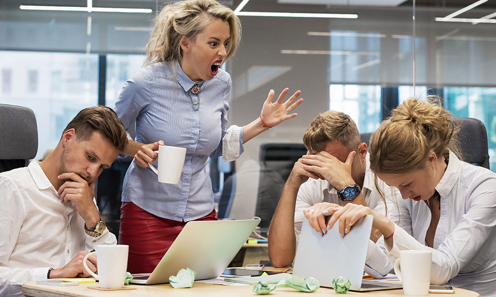 annoying-employee Picture of an employee complaining to coworkers at the job.