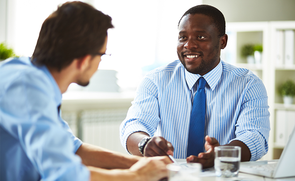 Photo of a manager speaking with employee.