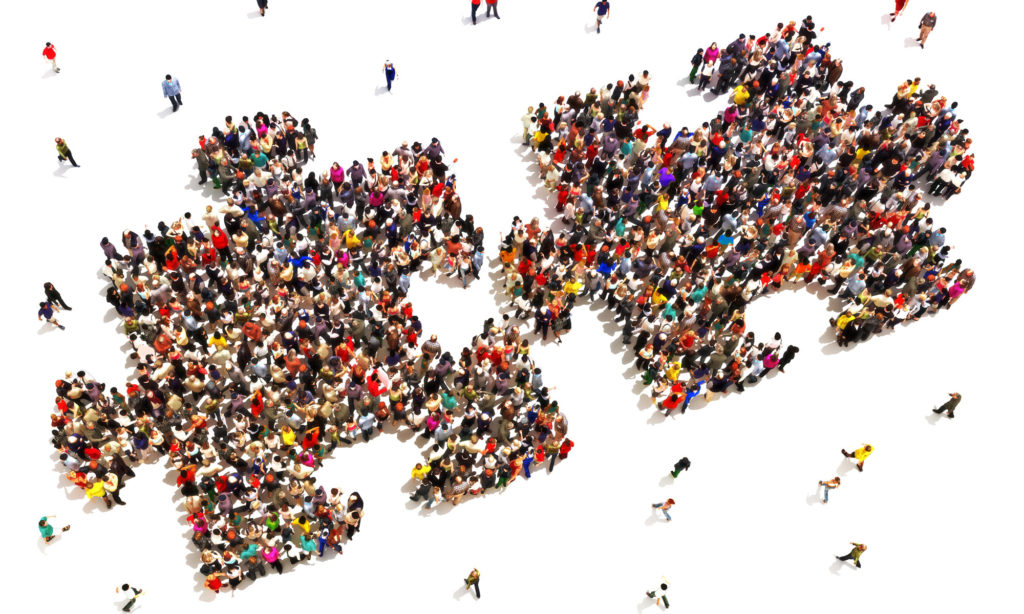 photo of two puzzle pieces each filled with hundreds of employees