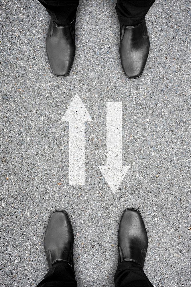 two-way-communication photo of two businessmen standing across one another with two arrows pointing back and forth between them