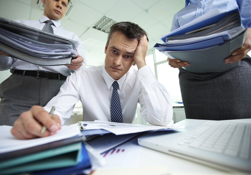 man stressed out with immense workload